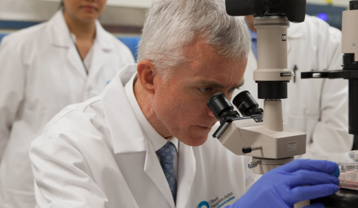 Scientist looking though a microscope